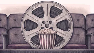 A film reel and striped popcorn box beside velvet cinema seats.