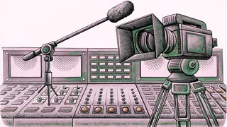 A studio camera and boom microphone stand near a control room console with lit buttons.