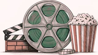 A brass film reel and blank clapper board rest beside a red-and-white striped popcorn container on a vintage counter.