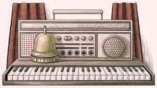 A brass hotel bell and a vintage radio sitting beside a piano keyboard on a table.