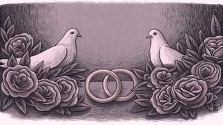 A gold ring nestles among crimson rose petals with white doves beside it.