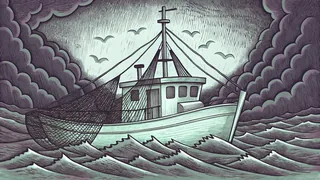 A fishing boat strains to haul in nets brimming with silvery fish from the ocean.