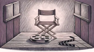 A director's chair and film canister rest on a wooden workbench.