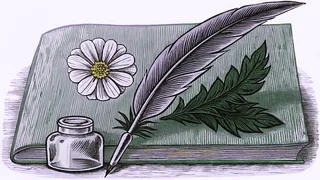A quill pen stands in a glass inkwell beside a pressed flower on a worn wooden desk.