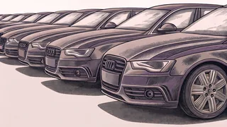 A row of modern sedans and sports cars displayed on a car dealership lot.