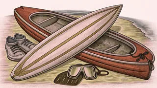 A bright surfboard floats on turquoise ocean water beside a red kayak with snorkeling gear packed inside.