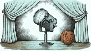 A stage spotlight stands beside a folded velvet curtain and a basketball on a polished gym floor.