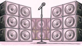 A silver microphone stands on stage beside tall concert speakers with a bright spotlight shining down.