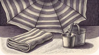 A striped beach umbrella with a folded towel and bucket on the sand.
