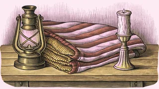 A brass lantern and candlestick stand on a wooden desk beside a folded travel blanket.