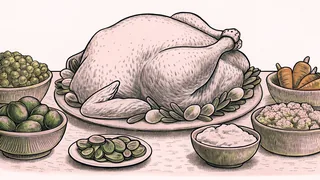 Traditional Thanksgiving dishes arranged on a harvest table with turkey as the centerpiece.