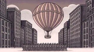 A giant colorful balloon floats above a marching band with drums on a city street.