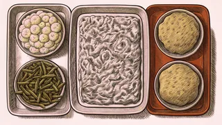 A golden cornbread loaf sits beside creamy mashed potatoes and a vegetable casserole.