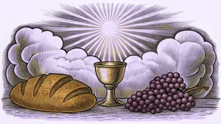 Loaf of bread and bunch of grapes on stone altar with light rays breaking through clouds