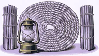 A large coil of rope and a lantern stand between two upright bundles of stakes tied with twine.
