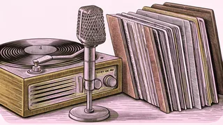 A record player with vinyl albums stacked beside an old microphone.