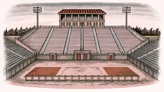 An athletic track with hurdles and equipment for field events.
