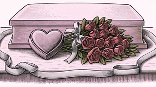 Red roses beside a heart-shaped chocolate box and ribbon on a table.