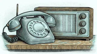 A vintage rotary telephone sits beside an old radio on a wooden shelf.