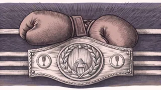 Red boxing gloves rest beside a championship belt on a boxing ring.