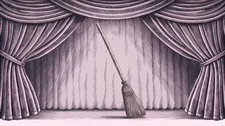 A broomstick rests against a velvet curtain, lit emerald green beneath a grand theater arch.